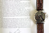 Panerai Luminor Marina luxury wristwatch with brown leather strap on open book