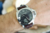 Luxury Panerai Luminor Marina wristwatch with black dial and brown leather strap on wrist
