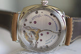 Close-up of Panerai watch caseback with visible Swiss mechanical movement and leather strap