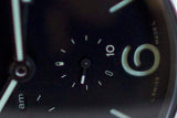 Close-up of a Swiss-made luxury watch face with luminous hands and numerals, subdial display.