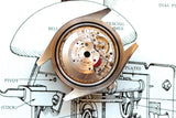 Close-up of a luxury watch movement resting on a technical watch blueprint.