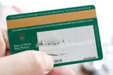Close-up of a green Rolex official guarantee card with a gold band and serial number.