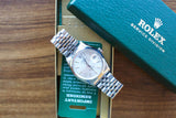 Silver Rolex Datejust watch with jubilee bracelet in a green Rolex Service Division box.