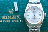 Rolex Oyster Perpetual Date luxury watch on a green Rolex Service Division background