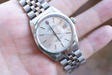 Close-up of a pre-owned Rolex Oyster Perpetual Date watch with a silver jubilee bracelet