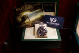 Rolex Submariner luxury watch in a green presentation box with original documentation.