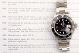 Rolex Submariner luxury watch with black dial and steel bracelet resting on a history text