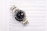 Rolex Submariner Date luxury watch with silver steel bracelet on a text background