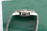 Side view of a luxury Swiss wristwatch with a stainless steel bracelet on a green background