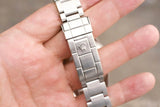 Close-up of a stainless steel luxury watch bracelet clasp featuring the Rolex crown logo