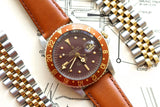Rolex GMT-Master luxury watch with brown dial and bezel on a brown leather strap.