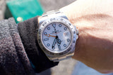 Close-up of a Rolex Explorer II luxury watch on a person's wrist