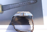 Side profile of a luxury Swiss-made watch with a stainless steel bracelet