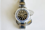 Stainless steel GMT luxury watch with black and blue bezel, silver bracelet on white background