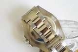 Close-up of stainless steel luxury watch bracelet and case back on white background