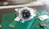 Stainless steel GMT watch with black and blue bezel on green wallet and tag