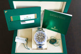 Rolex stainless steel watch with black and blue bezel in original box, warranty card, and booklet