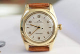 Vintage gold-tone Rolex Oyster Perpetual Bubbleback watch with tan leather strap