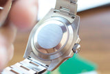 Close-up view of the brushed stainless steel case back of a luxury Swiss watch