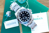 Pre-owned Rolex Submariner luxury watch with box, papers, and warranty card.