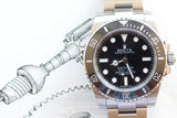 Close-up of a Rolex Oyster Perpetual Submariner luxury watch with a black dial and bezel.