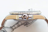 Close-up side view of a luxury gold and silver watch featuring a crown with a crown logo.