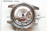 Detailed view of a luxury watch movement inside a stainless steel case.