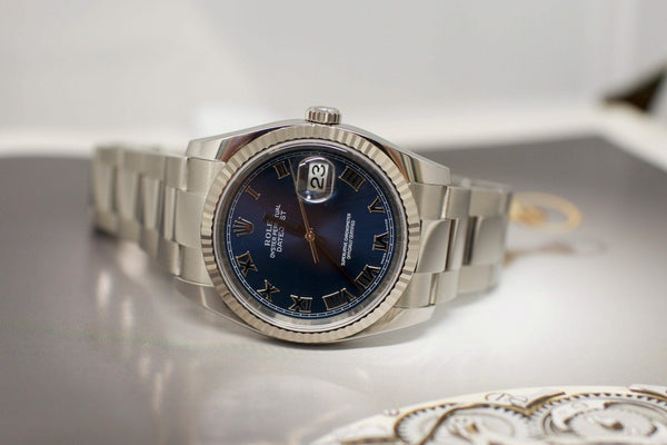 Stainless steel luxury watch with blue Roman numeral dial and date window on display