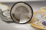 Stainless steel case back of a pre-owned luxury watch with engraved markings