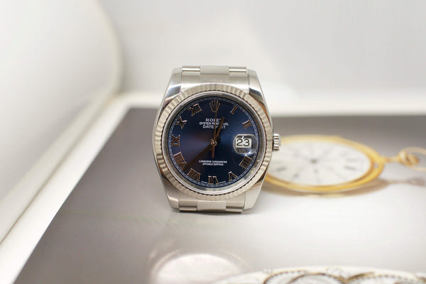 Stainless steel luxury watch with blue dial and Roman numerals, date displayed at 3 o'clock
