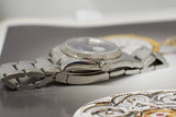 Close-up of stainless steel Swiss-made luxury watch with fluted bezel and bracelet