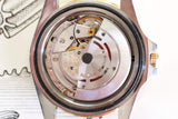 Close-up of vintage luxury Swiss watch movement with visible gears and rotor