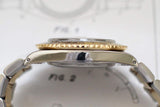 Close-up side view of a two-tone vintage luxury watch case and bracelet, gold bezel detail