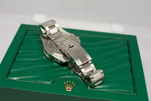 Stainless steel luxury watch with oyster bracelet on a green presentation box