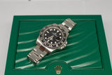 Luxury stainless steel GMT watch with black bezel on green textured display box