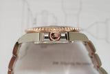 Side view of two-tone luxury Swiss watch with rose gold crown and polished bracelet