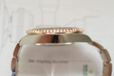 Side view of two-tone luxury watch case and bracelet with rose gold bezel