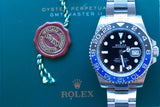 Rolex GMT-Master II luxury watch with blue and red bezel on a green presentation box