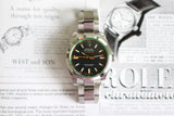 Stainless steel Rolex Milgauss luxury Swiss watch with black dial on magazine background