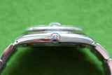 Close-up side profile of a luxury watch showing the crown and polished stainless steel case.