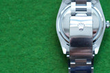 Back view of a stainless steel luxury watch with crown logo on the clasp
