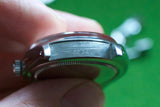 Close-up view of a luxury watch case back showing serial number engravings