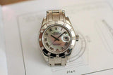 Silver women's luxury watch with diamond bezel and mother of pearl dial on a plan drawing