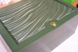 Green textured luxury watch box with gold crown emblem, elegant packaging