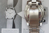 Close-up of a stainless steel luxury watch case back and bracelet with logo, on vintage watch ad.