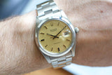 Vintage Rolex Oysterdate Precision stainless steel watch with champagne dial on wrist