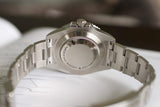 Close-up of stainless steel luxury Swiss watch case back and oyster bracelet