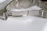Stainless steel Swiss watch clasp close-up with engraved details, open on white surface