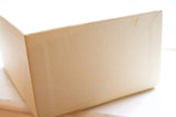Close-up of a plain beige textured box on a white surface