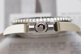 Close-up side view of a luxury stainless steel dive watch crown and bezel.